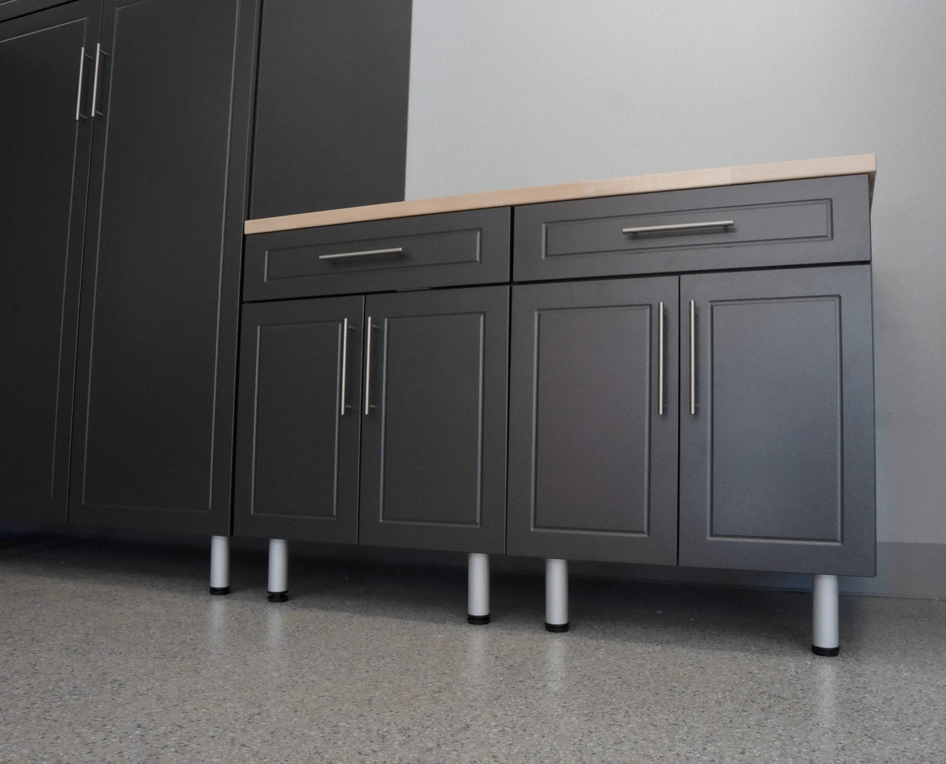 A kitchen with black cabinets and white counter tops.