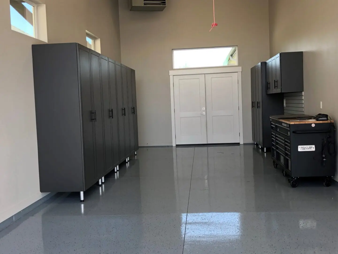 A room with many cabinets and a door.