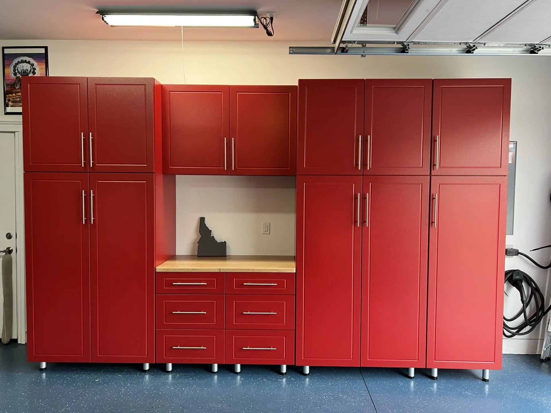 A red garage with cabinets and drawers in it